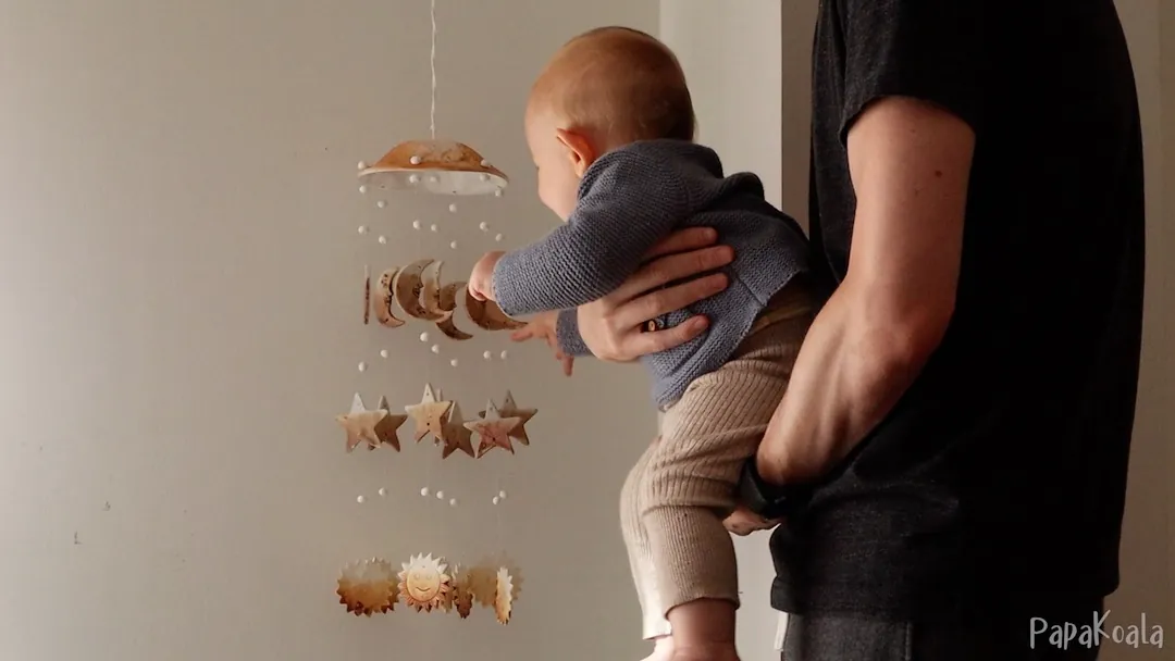 You hang a musical mobile within their reach, and they discover that it makes a sound when they touch it.